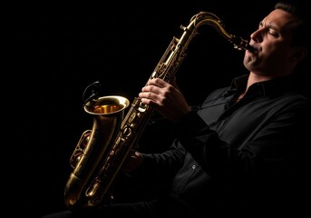 Fototapeta premium Saxophonist playing a saxophone with dramatic lighting on a solid black background