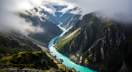 Aerial view of a turquoise river winding through a mountain valley