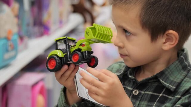 A child in retail toy shop makes a difficult choice between a red and a green tractor while shopping for a new toy.