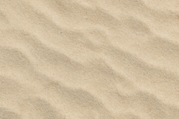 Close up of rippled golden sand texture with soft shadows