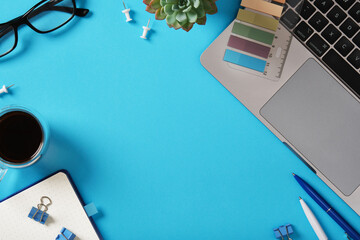 Workspace background with laptop, coffee, glasses, and stationery. Space for your text.