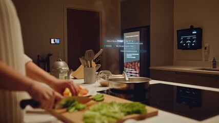 Woman prepares fresh vegetables while AI technology shows ingredients and instructions on futuristic interface screens.