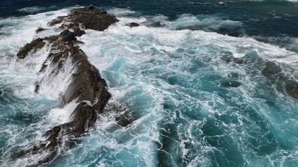 the ocean hitting the cliffs