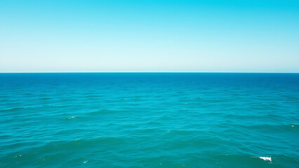 Obraz premium Vast Teal Ocean Under a Clear Sky