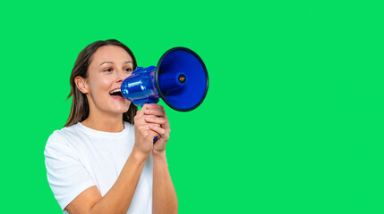 Young woman holding a blue megaphone and enthusiastically promoting an event against a vibrant green background
