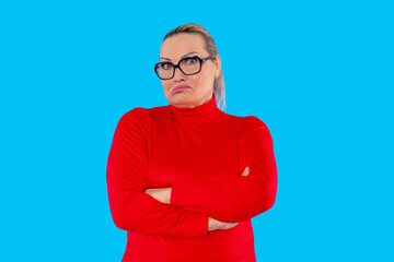 Expression of confusion and uncertainty during a casual moment in front of a bright blue background