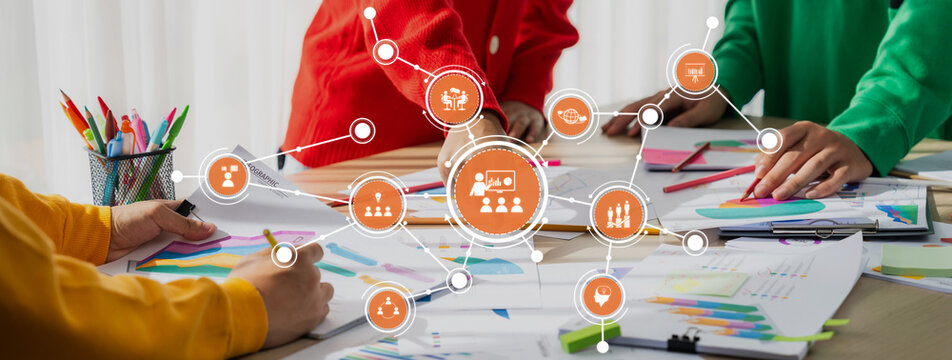 This image showcases a collaborative office environment where team members actively engage in creative processes using charts, graphs, and digital interfaces to drive innovative ideas. Amity