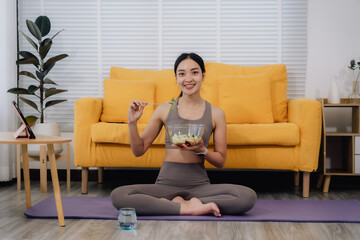 Obraz premium Healthy Woman Eating Salad at Home