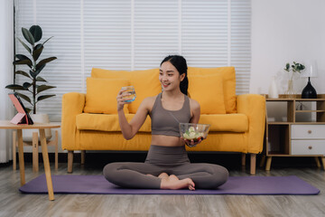 Obraz premium Healthy Asian Woman Meditating with Salad and Water
