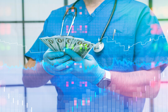 Doctor in blue scrubs and gloves holds hundred-dollar bills, with a dynamic financial graph and chart. Concept financial of the healthcare industry, including costs and medical finance.