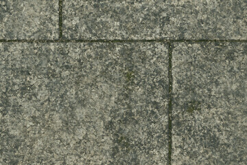 Rough textured stone wall with visible grout lines and subtle color variations