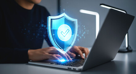 Person using laptop with digital shield and checkmark overlay for data protection and security online