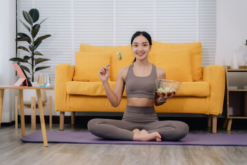 Obraz premium Healthy Woman Eating Salad After Yoga