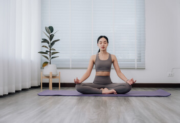 Serene Woman Meditating in Lotus Position at Home
