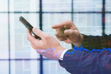 Businessman using smartphone with overlaid financial data, stock market charts and trading numbers in modern office environment. Concept mobile trading apps, fintech solutions and digital investment.