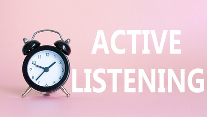 Active listening symbol. Beautiful pink background with alarm clock. Business and Active listening...