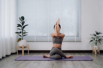 Woman Practicing Cow Face Pose in Studio