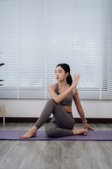 Woman Practicing Yoga Spinal Twist Pose
