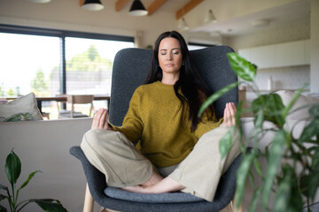 Woman meditating with hands in prayer position