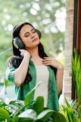 Relaxed woman enjoying free time, listening to music.