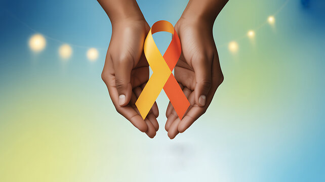 World suicide prevention day yellow and orange ribbon held in hands with bokeh lights