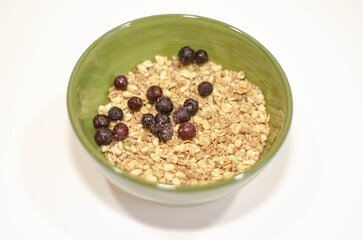 Healthy Granola Cereal with Berries in Green Bowl