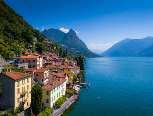 Lake Lugano, Valsolda, Italy. View of the lake, mountains and scenic village. A small Italian town by the lake in Albogasio Oria. Aerial drone view