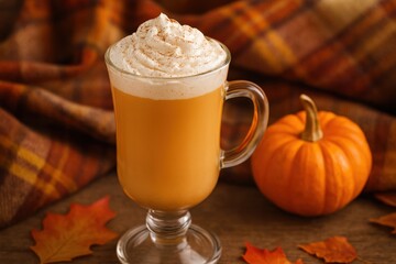 A Cozy Autumn Beverage: Creamy Pumpkin Spice Latte in a Glass with Whipped Cream and a Sprinkle of Cinnamon Surrounded by Fall Decorations