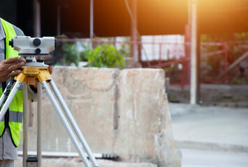 Engineers are adjusting the camera for level measurement in construction work.