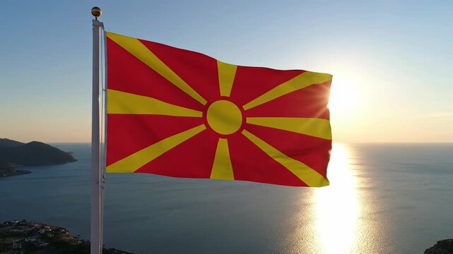 Flag of North Macedonia waving in the wind against the sea and sunset sky, symbolizing national pride, freedom, and unity, perfect for Independence Day celebrations and patriotic events - Powered by Adobe