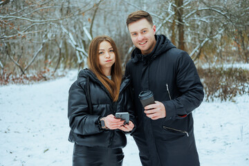 A Young Couple is Joyfully Enjoying Their Winter Together in a Delightful and Snowy Outdoor Setting, Fully Embracing the Season and Creating Lasting Memories amidst this Beautiful, Scenic Landscape