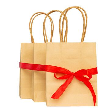 Crane bags tied with red senta with bowknot on white background, discount and shopping concept