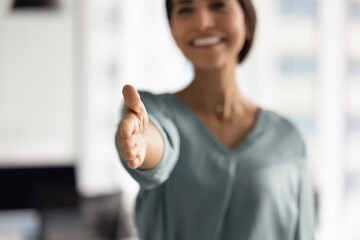 Close up of smiling HR manager woman greeting applicant, extending her hand for handshake, start...