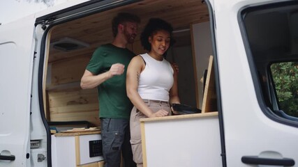 Couple working remotely from camper van