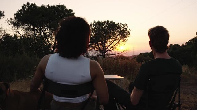 Couple enjoying sunset view during camping trip