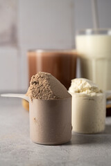 Protein powder and protein drinks, with scoops. Food supplement, bodybuilding, fitness and sport