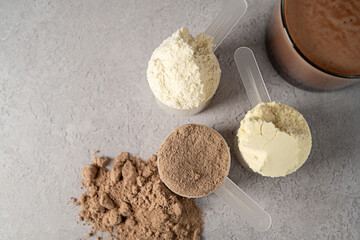 Protein powder and protein drinks, with scoops. Food supplement, bodybuilding, top view