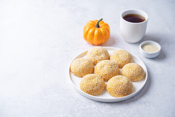 Pumpkin sesame seeds balls in a plate with tea