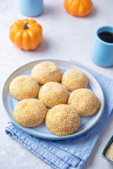 Pumpkin sesame seeds balls in a plate with tea