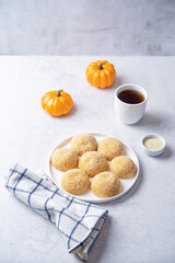 Pumpkin sesame seeds balls in a plate with tea