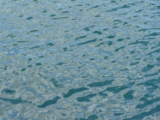 Gentle waves rippling across deep blue water surface