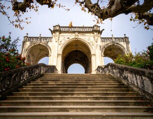 Fototapeta premium Grand stone stairway leading to ornate archway