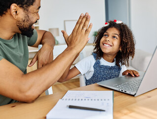 Father and daughter doing homework with laptop at home. Father and teenage daughter girl using laptop. Father and daughter giving high five hand to each other. Teamwork and cooperation concept