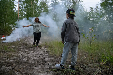 Family Playing and Running Through Smoke in Forest Nature