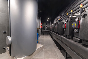A well-lit industrial facility features neatly arranged equipment, including large tanks and...