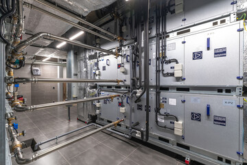 This mechanical room features multiple units for heating and cooling, showcasing advanced...