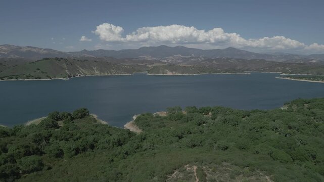 The Cachuma Lake water reservoir in California is shown from an aerial approaching view on a beautiful, summer day.