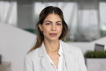 Head shot portrait of beautiful serious businesswoman, company CEO or executive manager dressed in...
