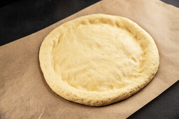 Raw pizza dough making pizza base tasty snack fresh delicious gourmet food background on the table rustic top view copy space