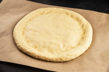 Raw pizza dough making pizza base tasty snack fresh delicious gourmet food background on the table rustic top view copy space